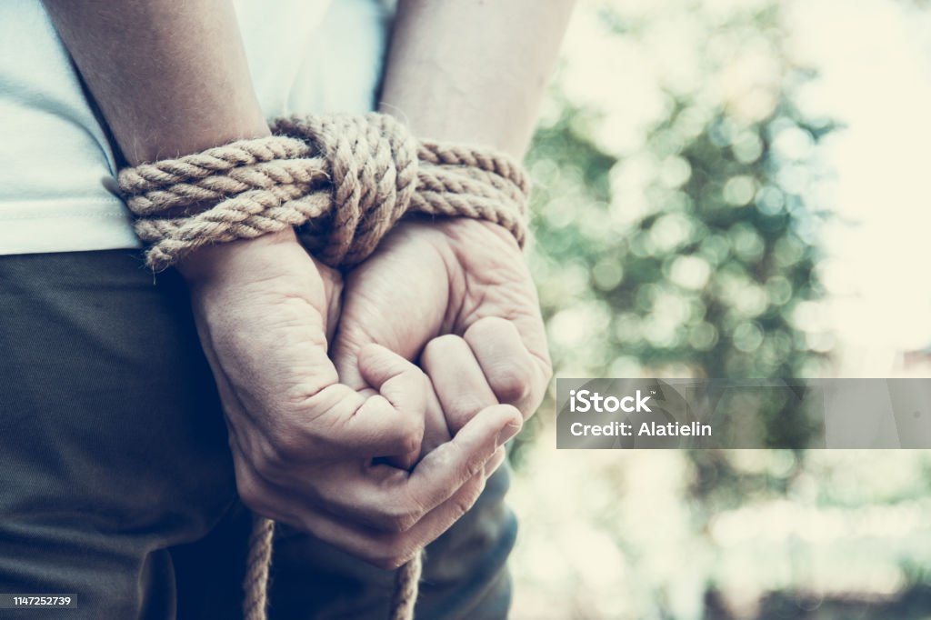 Man with hands tied. Hands tied up with rope. Restraint concept Rope Stock Photo