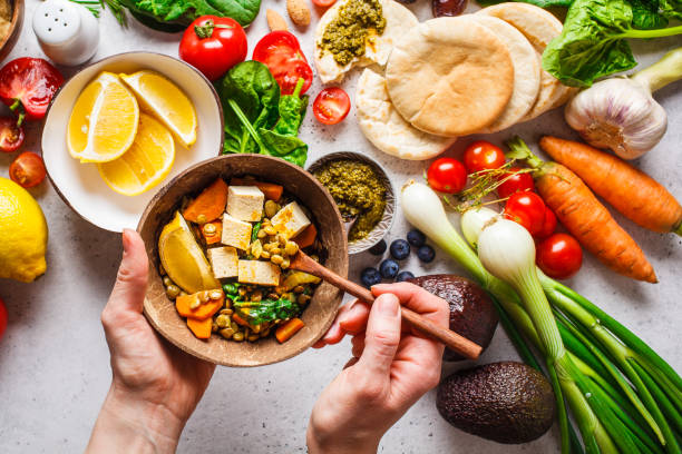 Healthy vegetarian food background. Vegetables, pesto and lentil curry with tofu. Healthy vegetarian food background. Vegetables, hummus, pesto and lentil curry with tofu. diet foods stock pictures, royalty-free photos & images