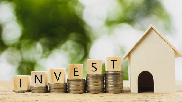 Property investment, home loan, house mortgage ,real estate financial concept. Property investment, home loan, house mortgage ,real estate financial concept. Money coin stack growing with wooden residential house model. Depicts a growth stock market about real estate and invest. legacy concept photos stock pictures, royalty-free photos & images