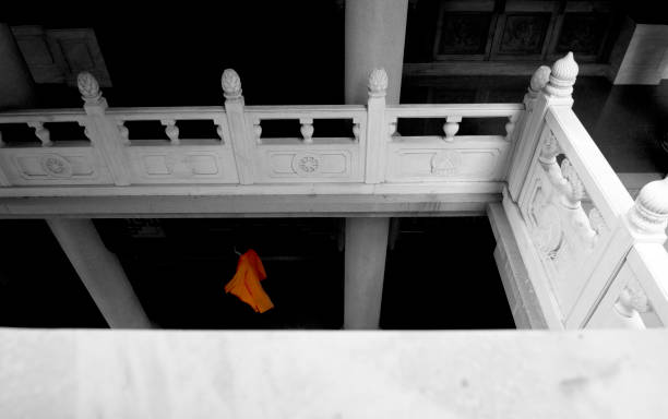 Monk of Jing'an Temple Temple architecture photography to create geometrical placement with one unclear view of a monk. black and white travel travel destinations monk stock pictures, royalty-free photos & images