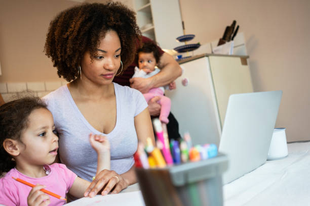 istock Mother and daughter's using laptop at home 1147257937
