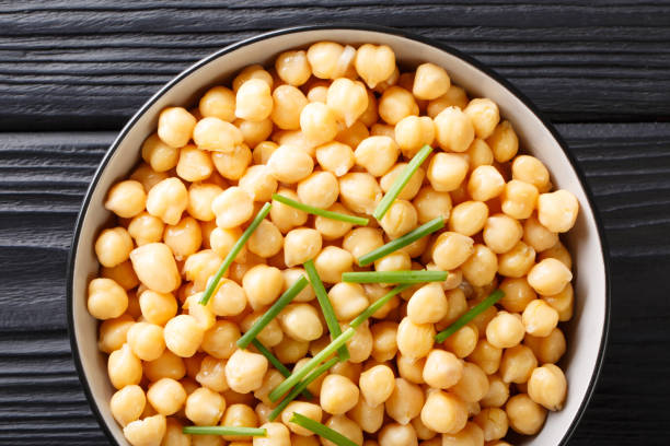 istock Organic snack boiled chickpeas close-up in a black bowl. horizontal top view 1147258609