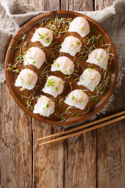 istock Chinese dim sum with shrimps served with microgreen close-up. Vertical top view 1147258657