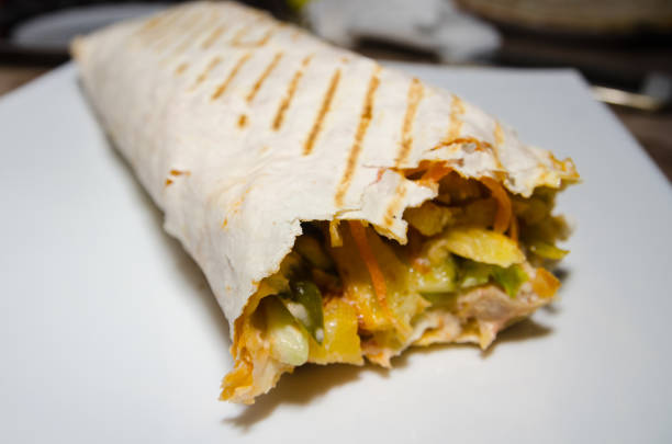 istock half of shawarma on white plate 1147259341