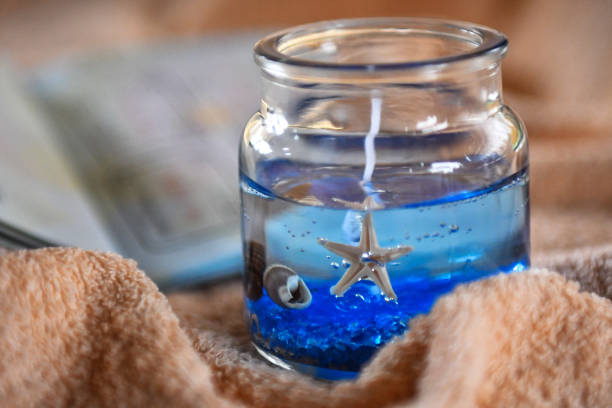 istock Beach themed candle and open passport with stamps 1147260632