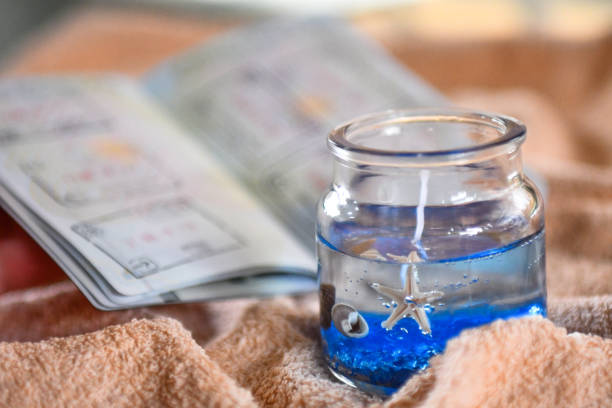 Beach themed candle and open passport with stamps
