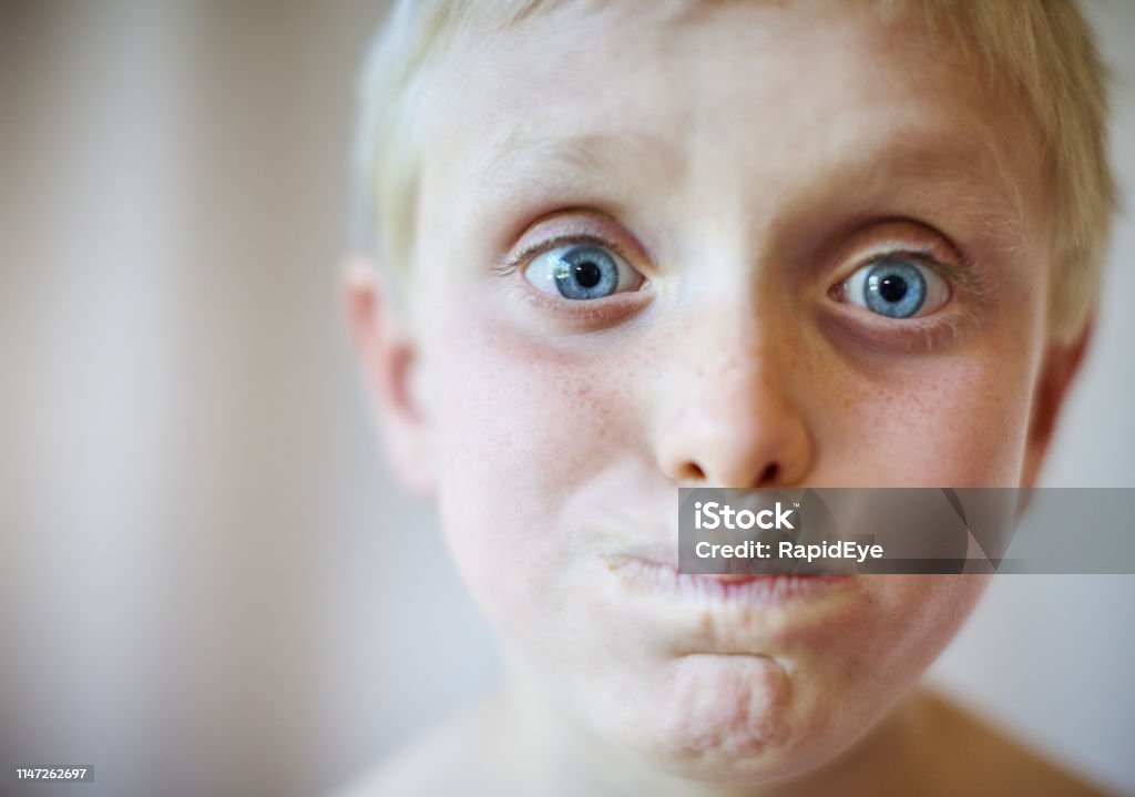 Blueeyed Blond Boy Pulls A Funny Face Stock Photo - Download Image Now -  Holding Breath, Child, Boys - iStock