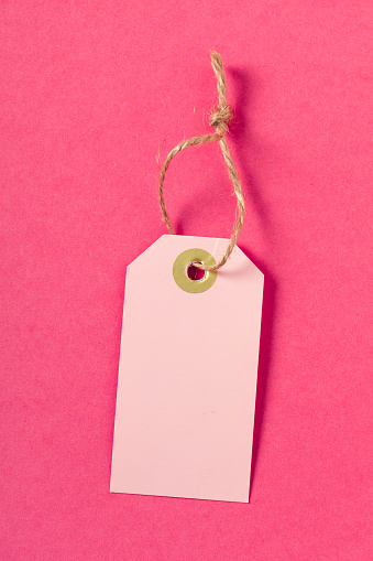 Blank  greeting card or tag  on pink  background