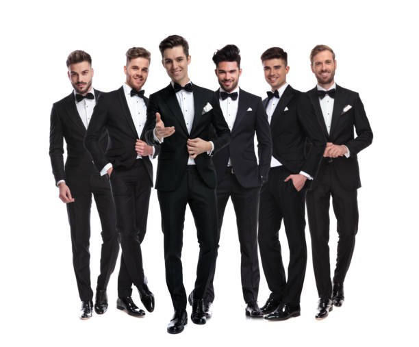 istock man in tuxedo pointing hand in front of his team 1147266287