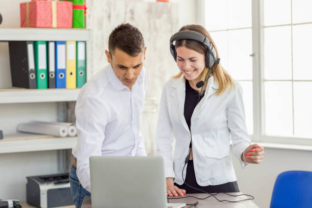 istock Cheerful coworkers working on computer in the office 1147266377