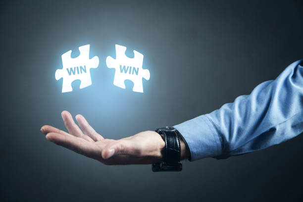 istock Man holding puzzle. Win-Win. Business concept 1147266443