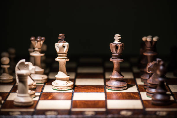 istock Close-Up Of Chess Board Against Black Background 1147269006