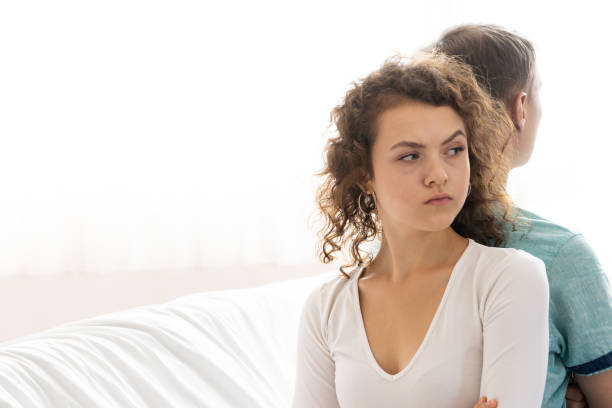 istock Couple having problems in relationship, Young upset girl sitting on back side her boyfriend 1147271905