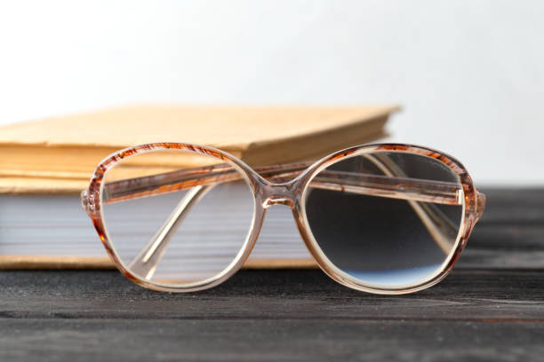 istock eyeglasses and book on the table 1147275452