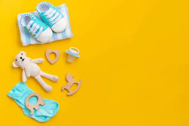 Photo of baby accessories for newborns on a colored background. selective focus.