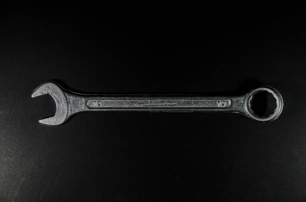 top view of a silver wrench on black background - fork wrench imagens e fotografias de stock