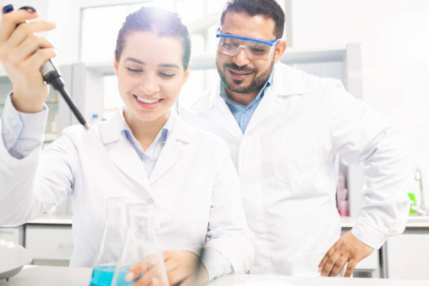 istock Chemists performing experiment in laboratory 1147277039
