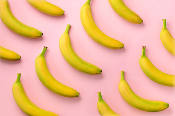 istock Colorful fruit pattern. Bananas over pink background. Top view. Pop art design, creative summer concept. Minimal flat lay style. 1147277291