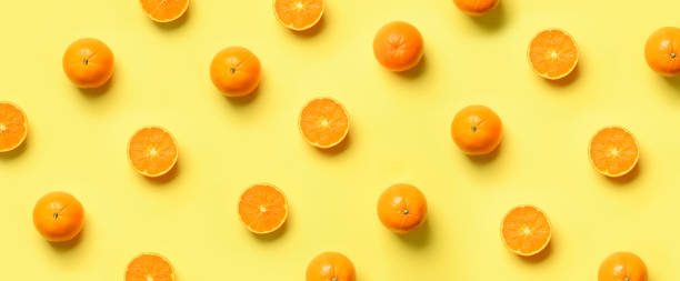 istock Fruit pattern of fresh orange slices on yellow background. Top view. Copy Space. Pop art design, creative summer concept. Half of citrus in minimal flat lay style. Banner. 1147277356