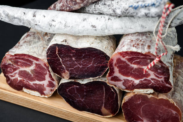 istock Smoked and dried meat on a black background 1147277396