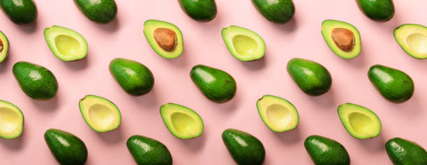 istock Avocado pattern on pink background. Top view. Banner. Pop art design, creative summer food concept. Green avocadoes, minimal flat lay style. Banner 1147277397