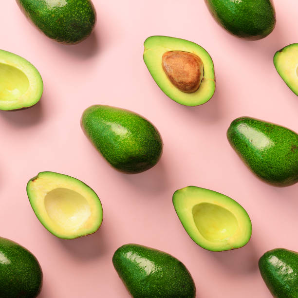 istock Avocado pattern on pink background. Top view. Banner. Pop art design, creative summer food concept. Green avocadoes, minimal flat lay style. Square crop 1147277407