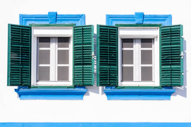 istock Two old windows with green wood shutters 1147277414