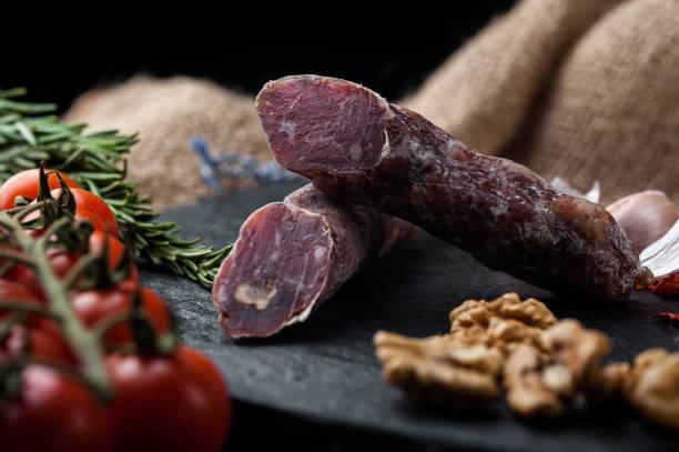 istock Smoked and dried meat on a black background 1147277419