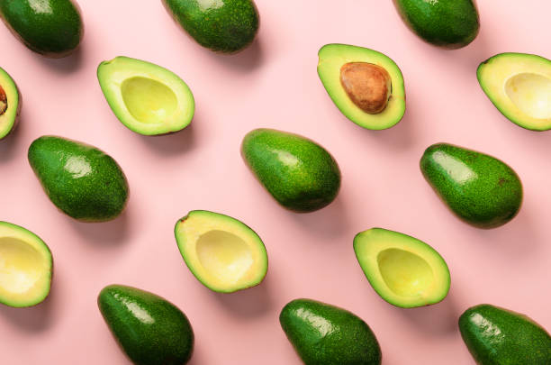 istock Avocado pattern on pink background. Top view. Banner. Pop art design, creative summer food concept. Green avocadoes, minimal flat lay style. 1147277455