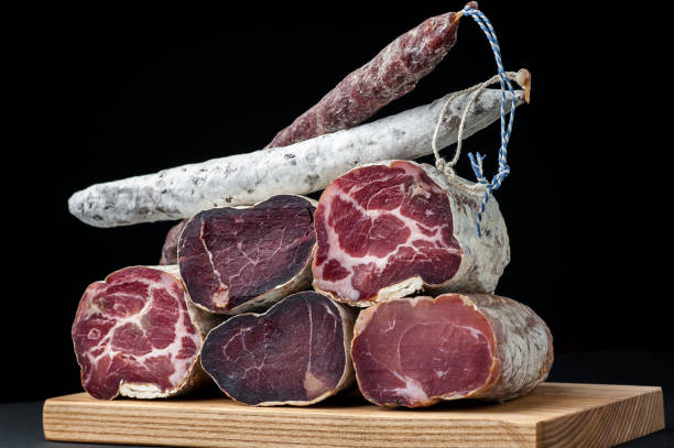 istock Smoked and dried meat on a black background 1147277537