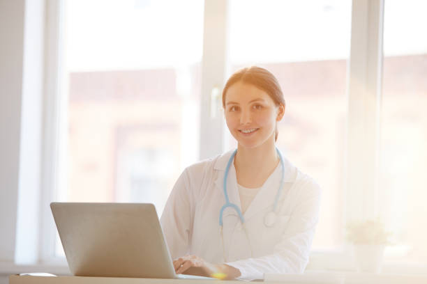 istock Woman Doctor Posing at Desk 1147277589