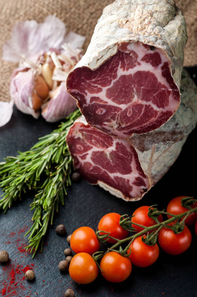 istock Smoked and dried meat on a black background 1147277613