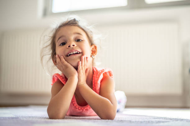 istock Beautiful little girl playing on carpet 1147278694