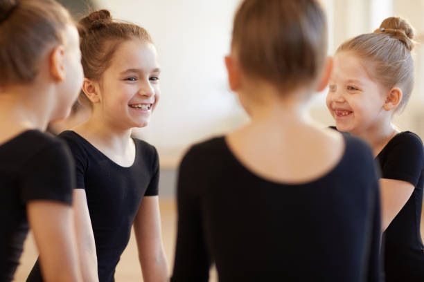 girls giggling in dance class - round bale imagens e fotografias de stock
