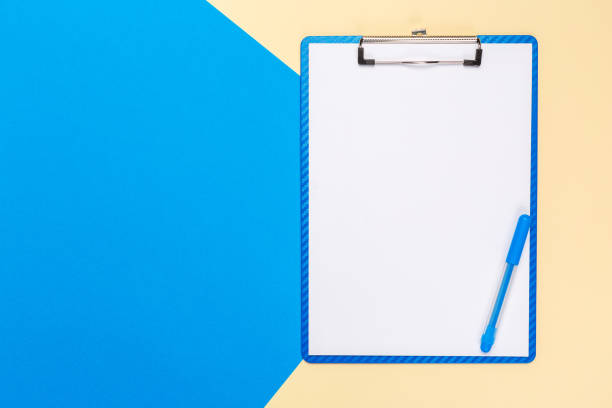 istock Blank paper notepad on bright bicolor background for your design, top view 1147279167