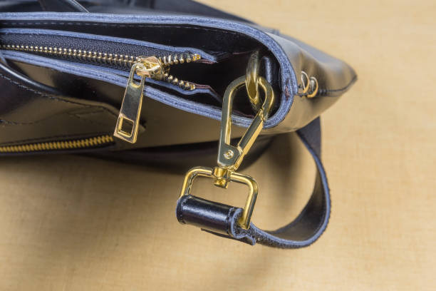 istock Yellow metallic bag accessories on the black handbag 1147281336