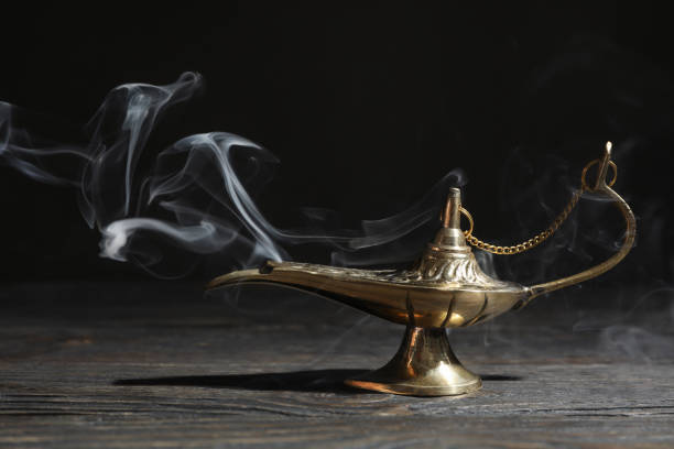istock Magic Aladdin Lamp on wooden table against dark background 1147281981