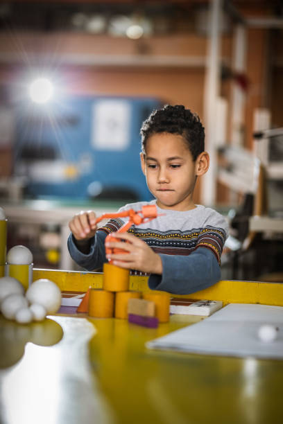istock African American little boy building something in laboratory for school science project. 1147282075