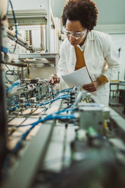 istock African American engineer adjusting machine part while working on scientific experiment in a laboratory. 1147282116