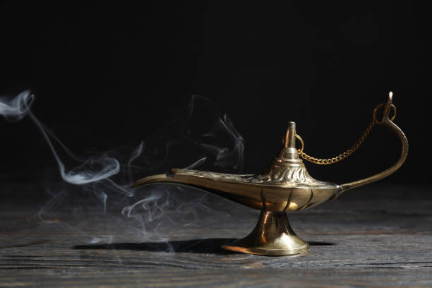istock Magic Aladdin Lamp on wooden table against dark background 1147282805