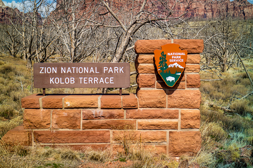 Zion National Park, UT, USA - March 18, 2018: The A welcoming signboard at the entry point of the preserve park