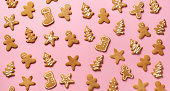 Christmas gingerbread cookies on pink background. Banner. Top view, copy space. New year concept