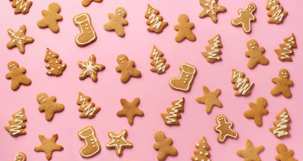 Christmas gingerbread cookies on pink background. Banner. Top view, copy space. New year concept Christmas gingerbread cookies on pink background. Banner. Top view, copy space. New year concept. christmas cookies pattern stock pictures, royalty-free photos & images
