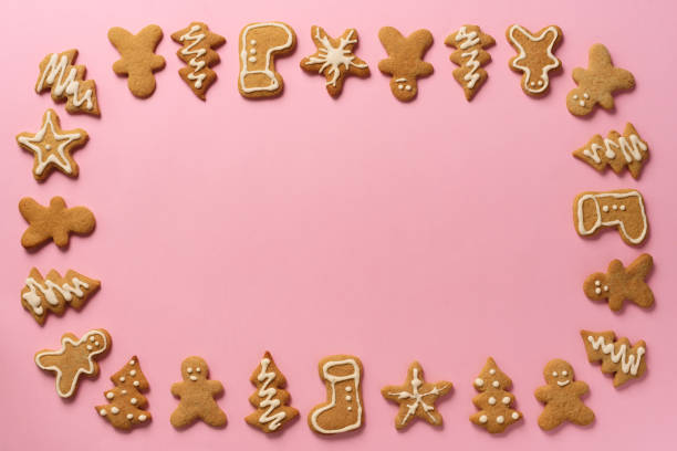 istock Frame of Christmas gingerbread cookies on pink background with copy space. Pattern of gingerbread men, snowflake, star, fir-tree, boot shapes. New year concept. Top view, flat lay 1147284716