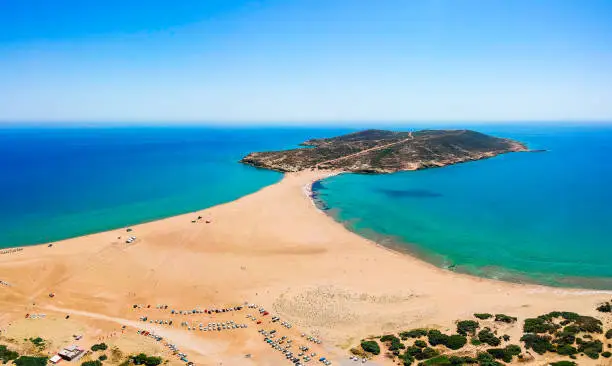 Photo of Aerial birds eye view drone photo Prasonisi on Rhodes island, Dodecanese, Greece. Panorama with nice lagoon, sand beach and clear blue water. Famous tourist destination in South Europe