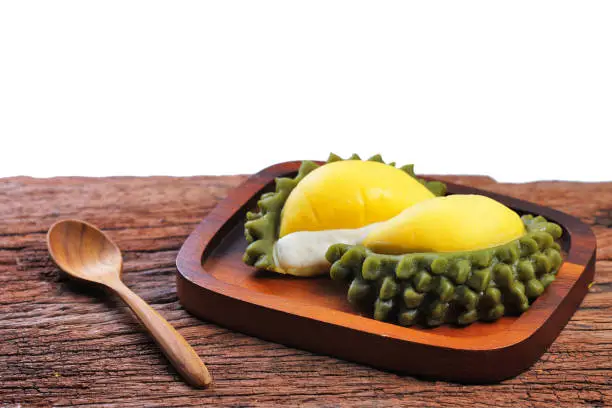 Photo of Thai dessert : Durian mochi or moon cake isolated on white background with path. Durian daifuku on wood chop, Moon cake for Mid autumn festival, Chinese happy new year and Moon festival. Still life in studio.