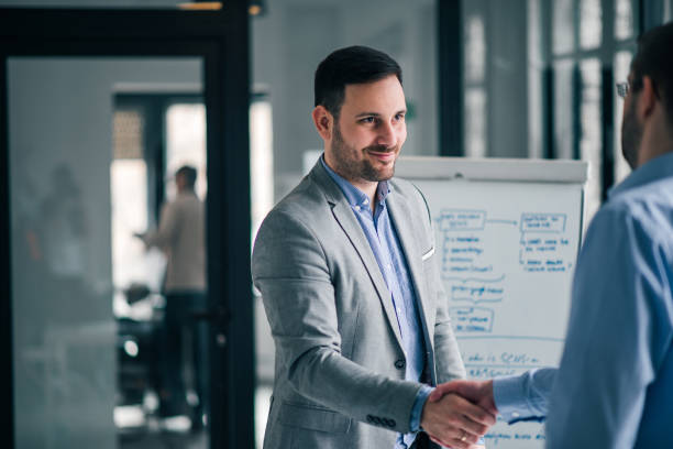 istock Confident businessman shaking hands with a colleague or a client. 1147288077