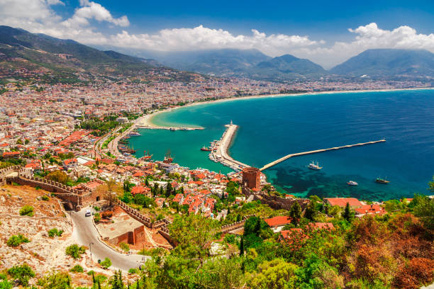 landscape with marina and kizil kule tower in alanya peninsula, antalya district, turkey, asia. famous tourist destination with high mountains. part of ancient old castle. summer bright day - província de antália imagens e fotografias de stock