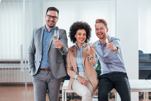 happy attractive business people holding glass of champagne. - party business toast champagne imagens e fotografias de stock