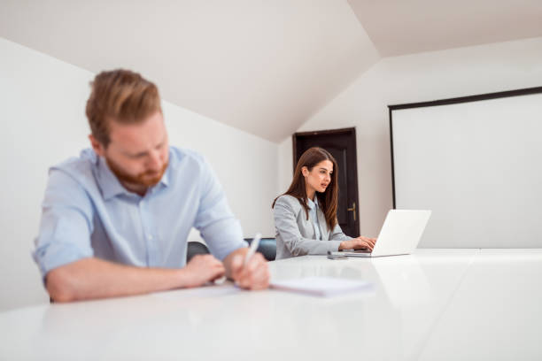 istock Two colleagues working at bright coworking office. 1147289188